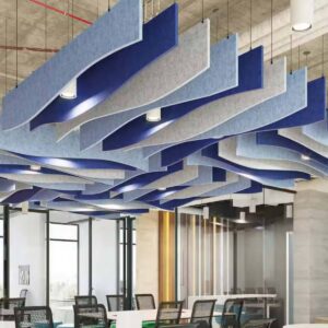 Paneles acústicos de techo Bilnora suspendidos verticalmente con diseño ondulado en tonos azul y gris, instalados sobre una oficina contemporánea.